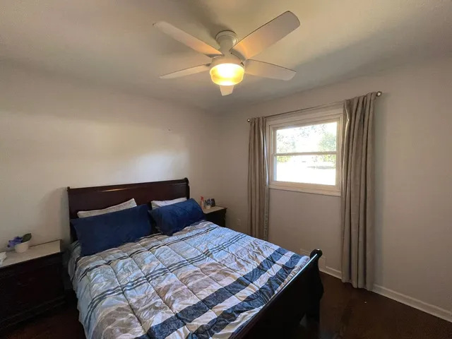 a bedroom with a bed and window