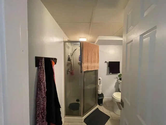 a bathroom with a toilet a sink and mirror