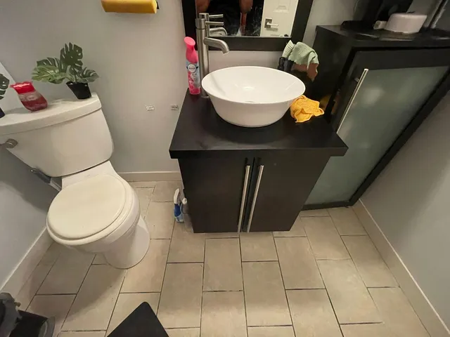 a bathroom with a sink toilet and a mirror
