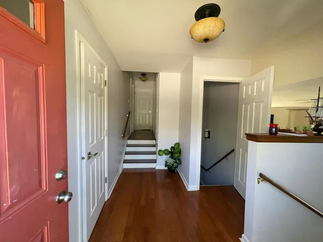 a view of entryway and hall with wooden floor