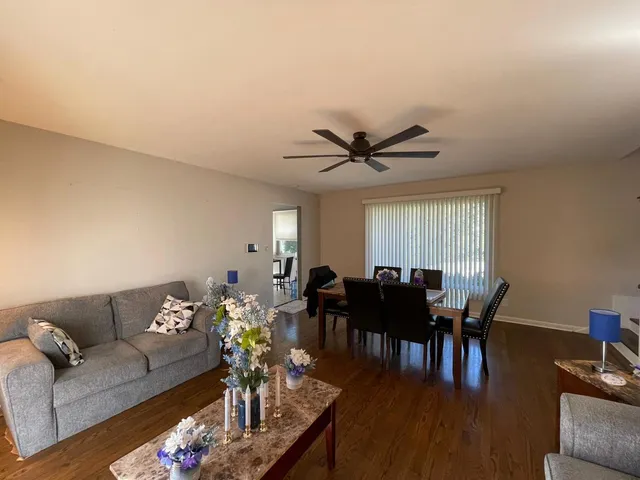 a living room with furniture dining area and a window