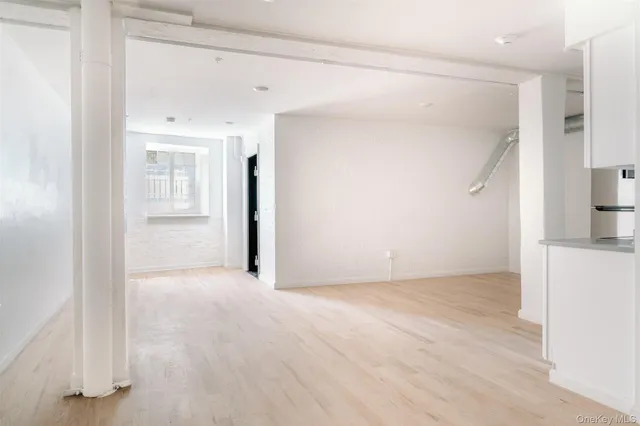 a view of a kitchen with a refrigerator a microwave and a sink