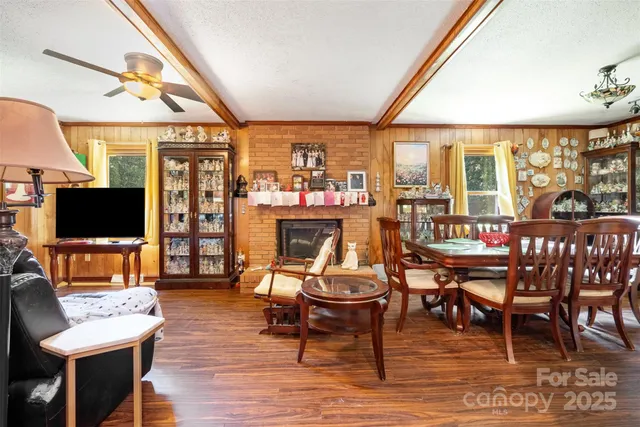 a living room with furniture a flat screen tv and a floor to ceiling window