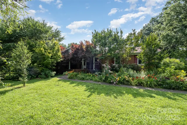 a view of a house with a yard and sitting area