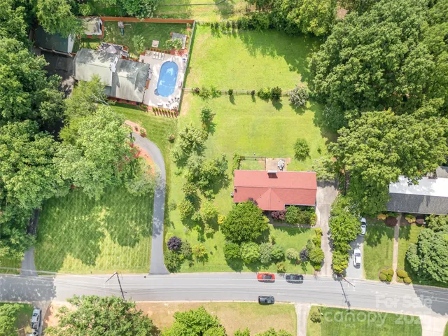 an aerial view of residential house with outdoor space and swimming pool