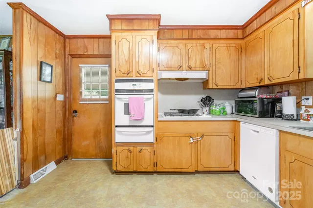 a kitchen with stainless steel appliances granite countertop a refrigerator and cabinets