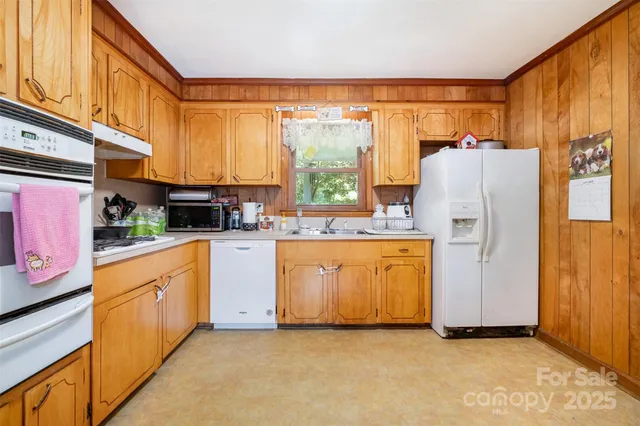 a kitchen with stainless steel appliances a refrigerator sink and cabinets