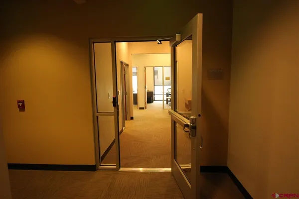 a kitchen with a refrigerator a stove and a sink with wooden floor