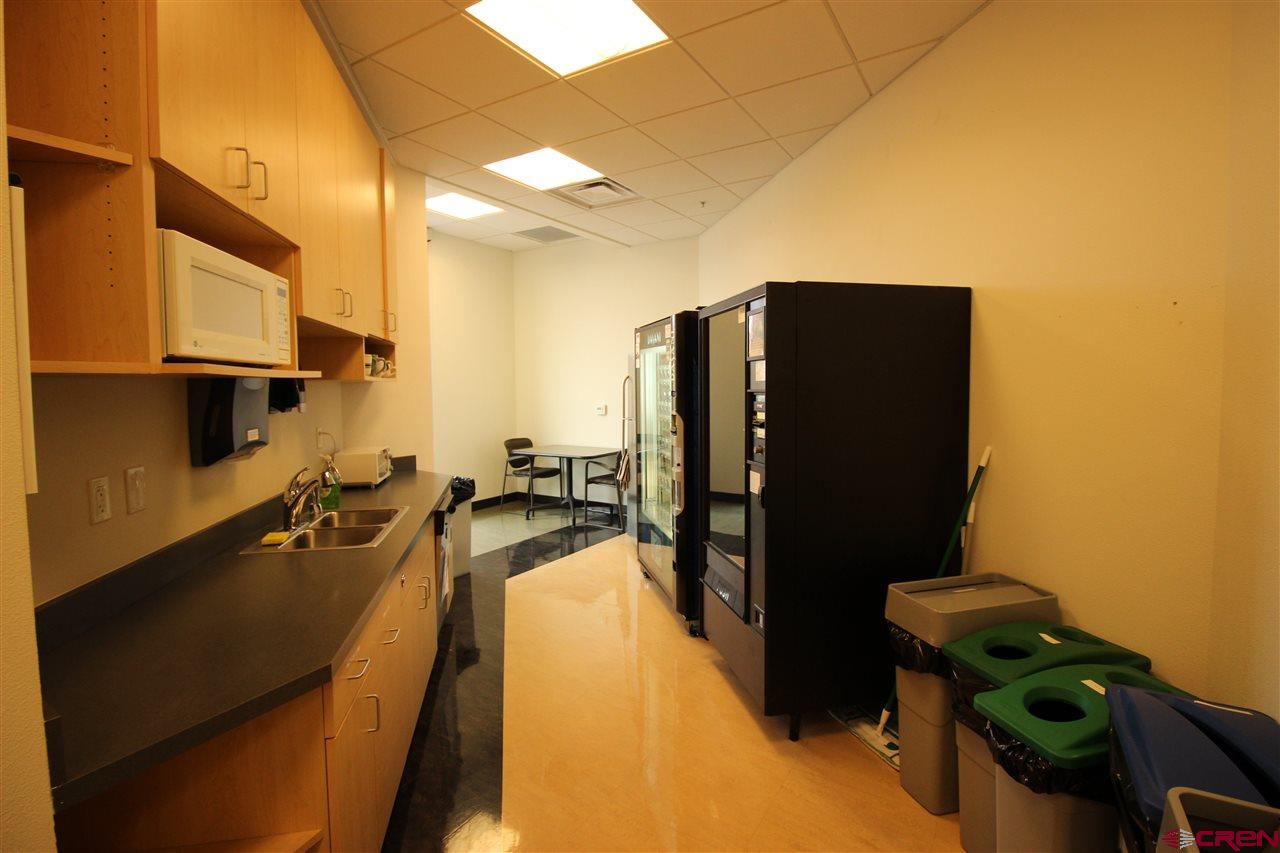 175 Mercado Street, Unit 234 Durango, CO 81301 - Photo 14 of 22 a kitchen with a refrigerator a stove and a sink with wooden floor