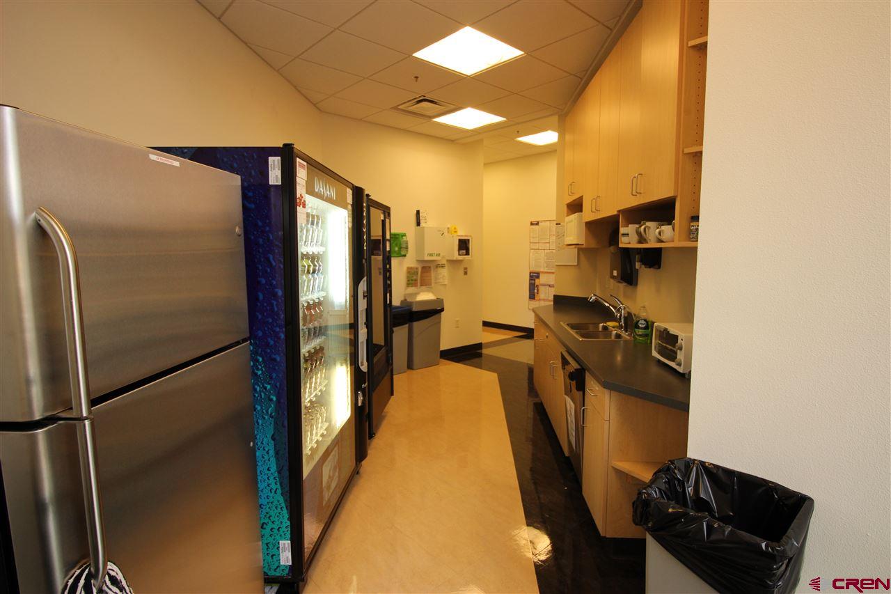 175 Mercado Street, Unit 234 Durango, CO 81301 - Photo 15 of 22 a view of a refrigerator in kitchen and utility room with wooden floor