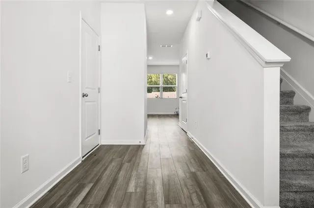 a view of hallway with wooden floor