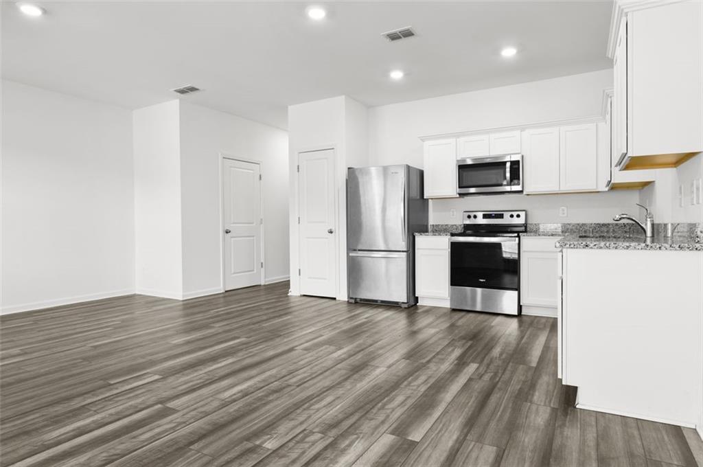 2615 Senegal Way, Unit 2615 Atlanta, GA 30331 - Photo 5 of 20 a kitchen with stainless steel appliances a refrigerator and a stove top oven