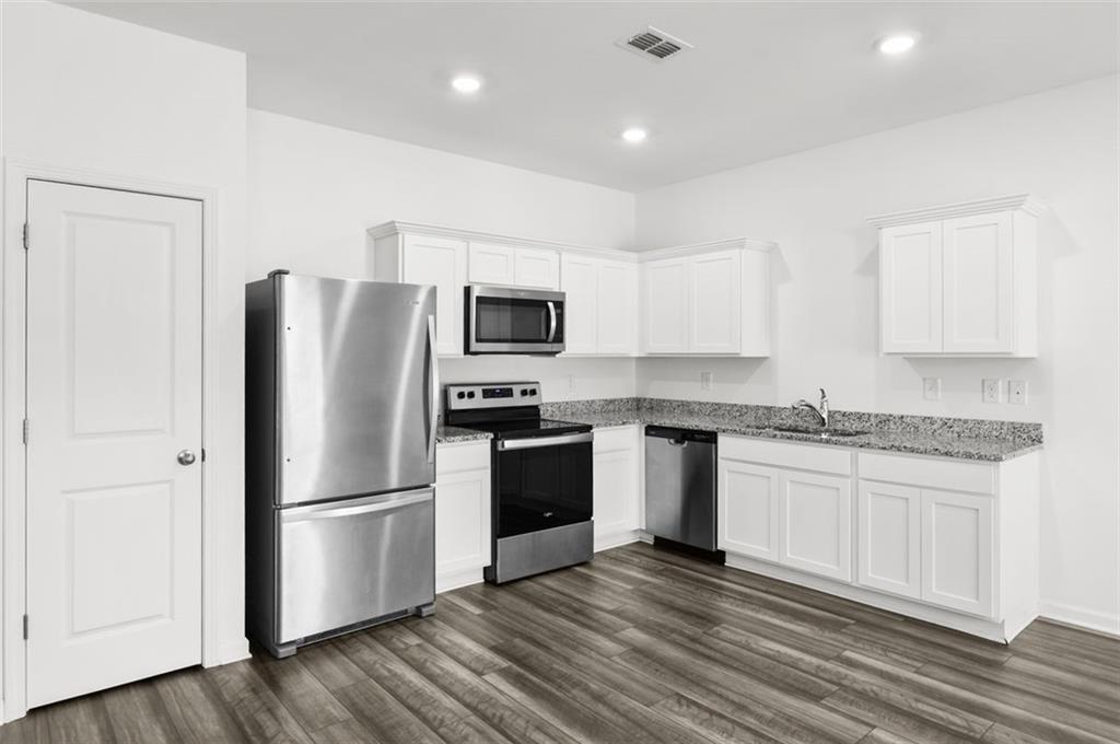 2615 Senegal Way, Unit 2615 Atlanta, GA 30331 - Photo 7 of 20 a kitchen with a refrigerator cabinets and wooden floor