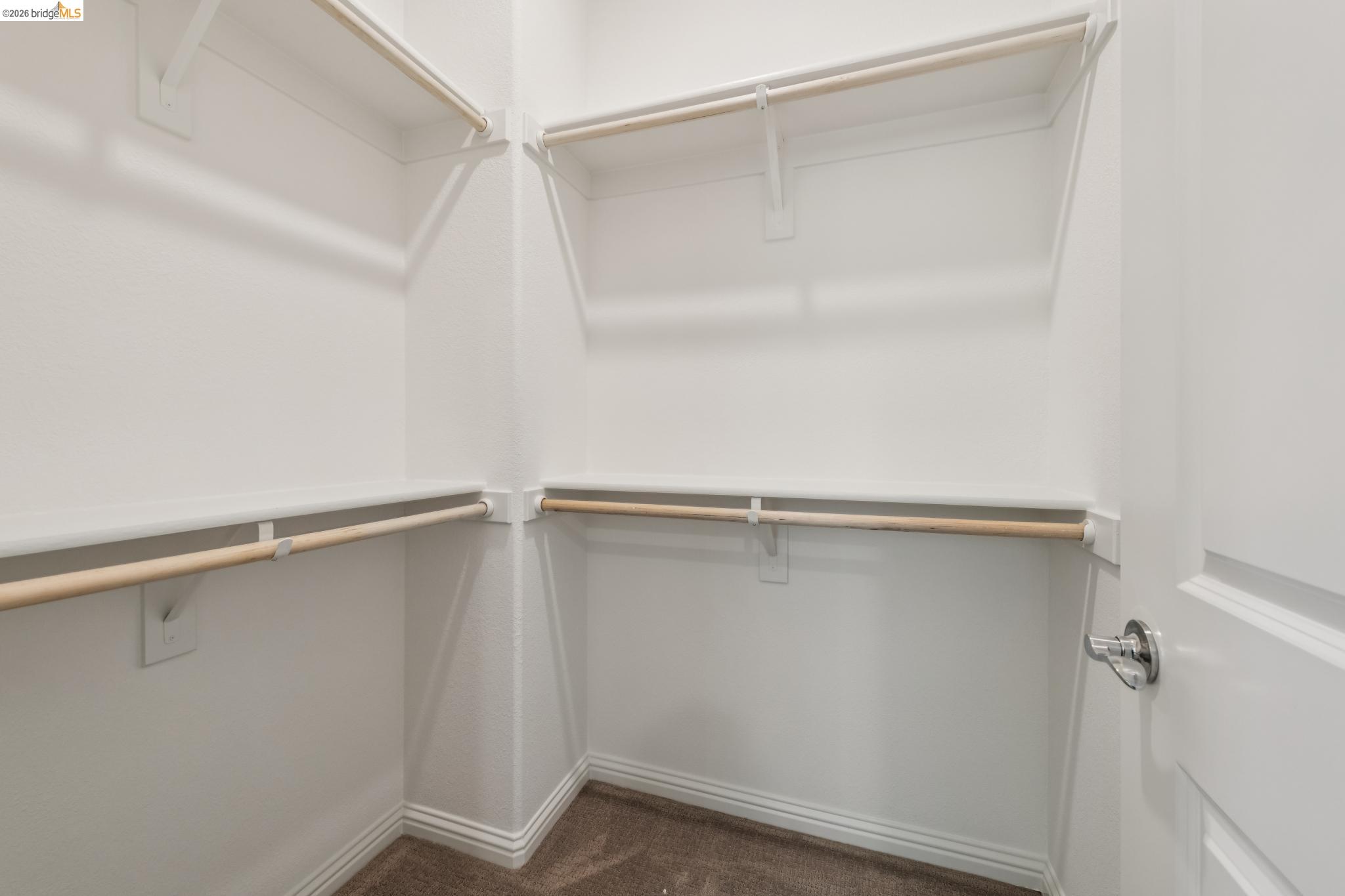 24157 Amaranth Loop Hayward, CA 94541 - Photo 46 of 63 Walk-in closet featuring white shelving and hanging rods