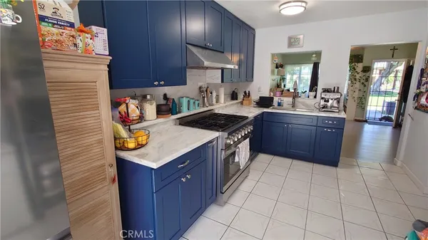 a kitchen with stainless steel appliances granite countertop a stove a sink dishwasher and cabinets