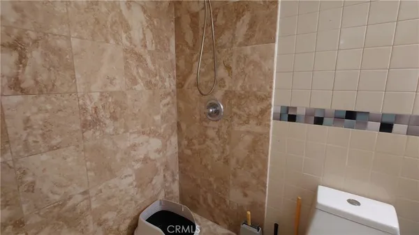 a bathroom with a shower and a sink