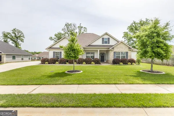 a front view of a house with a yard
