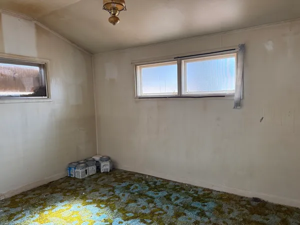 a kitchen with granite countertop a refrigerator and a sink