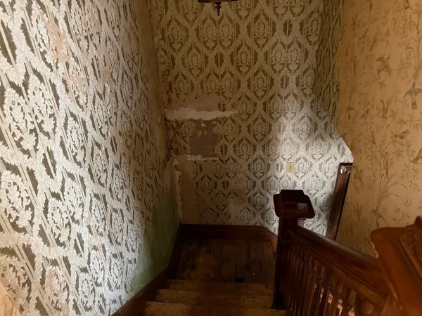 a view of an empty room and bathroom