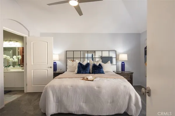 a bed room with a bed and a lamp