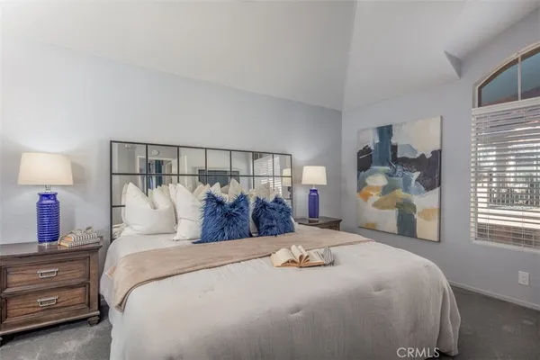a bedroom with a bed and a painting on the wall