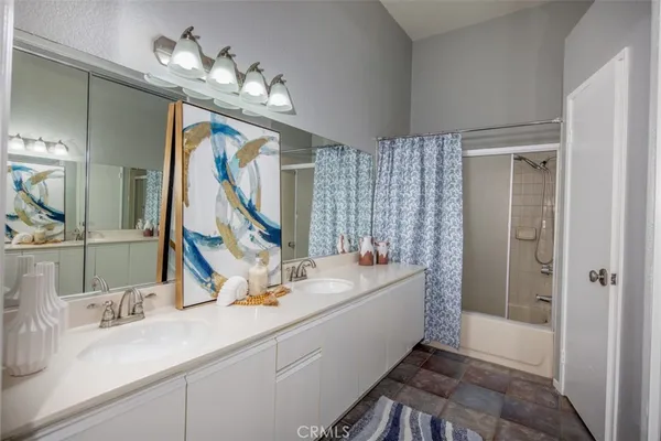 a spacious bathroom with a tub sink and mirror