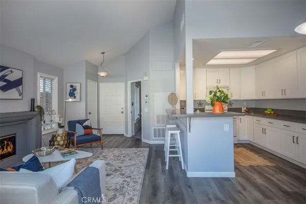 a kitchen with stainless steel appliances granite countertop a refrigerator a stove and a wooden floors