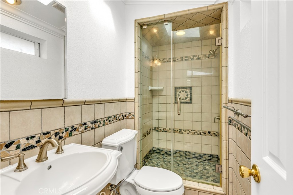 1724 El Rey Road San Pedro, CA 90732 - Photo 41 of 51 a bathroom with a sink mirror toilet and shower