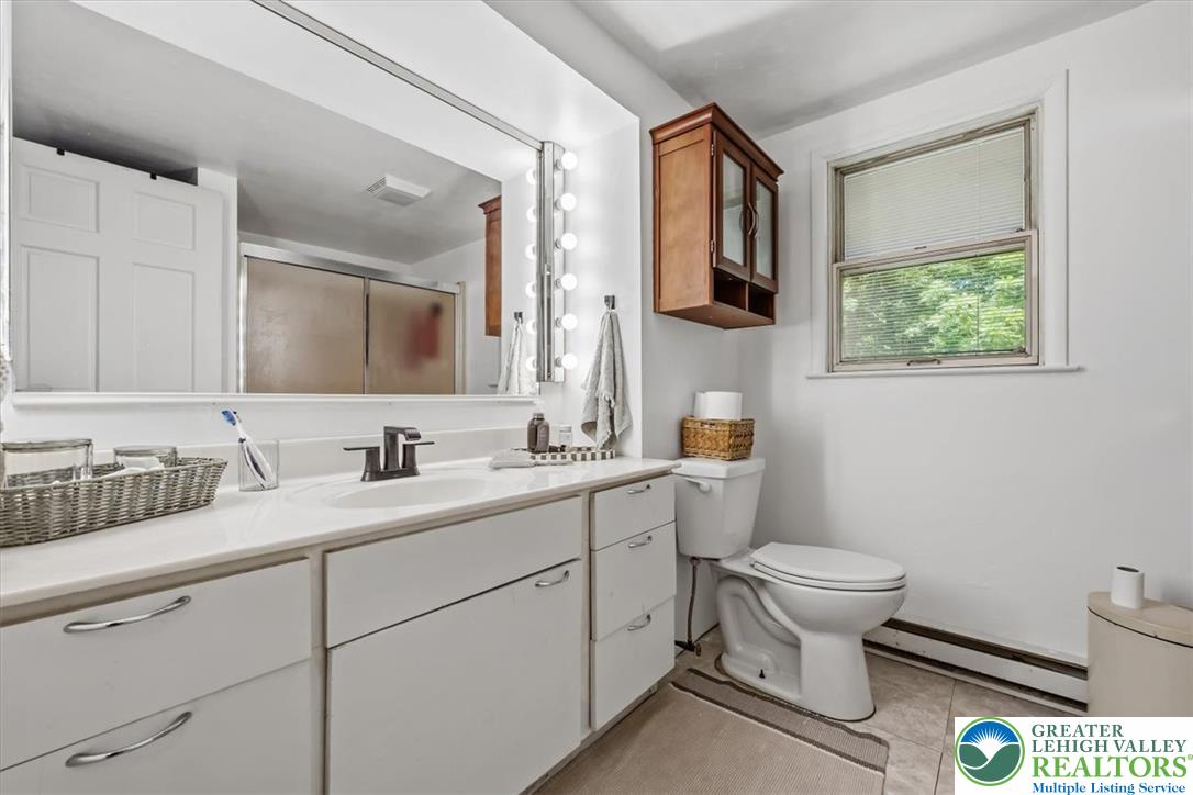 5340 2nd Street Whitehall, PA 18052 - Photo 13 of 30 Well-lit primary bathroom featuring a spacious vanity with ample storage and a window offering natural light.