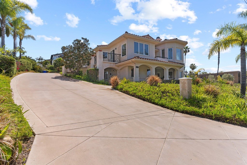 1615 Burgundy Road Encinitas, CA 92024 - Photo 1 of 1 a front view of a house with a yard and trees