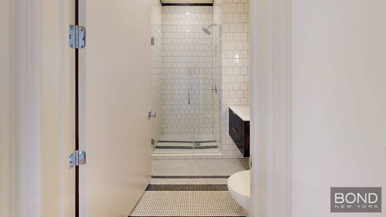 1031 Lorimer Street, Unit 2 Brooklyn, NY 11222 - Photo 13 of 15 a bathroom with a toilet and a shower