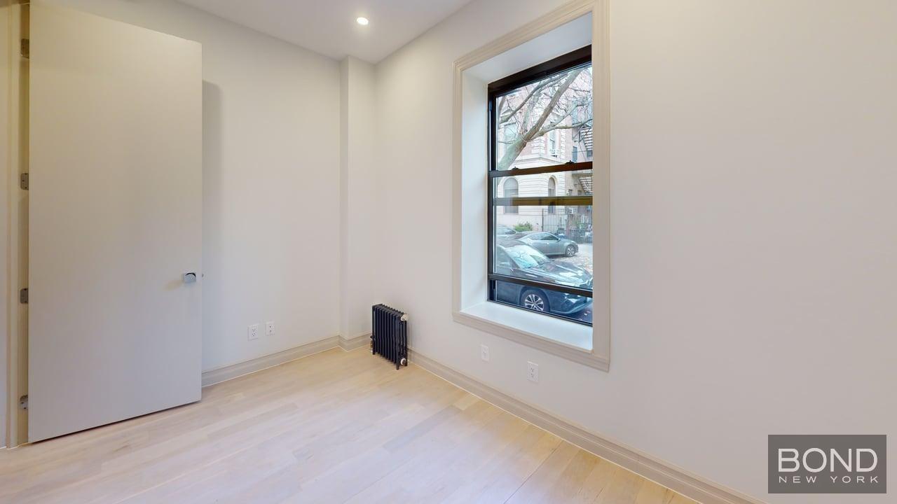 1031 Lorimer Street, Unit 2 Brooklyn, NY 11222 - Photo 14 of 15 a view of an empty room with a window