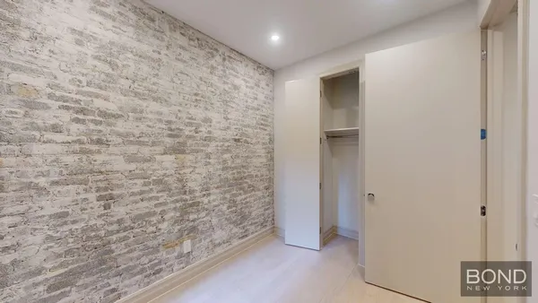 a bathroom with a sink shower and a mirror