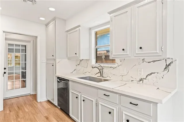 a bathroom with a sink and cabinets