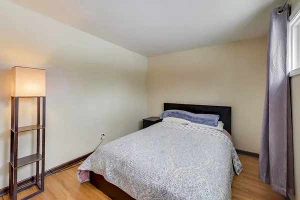 a bedroom with a bed and a night stand
