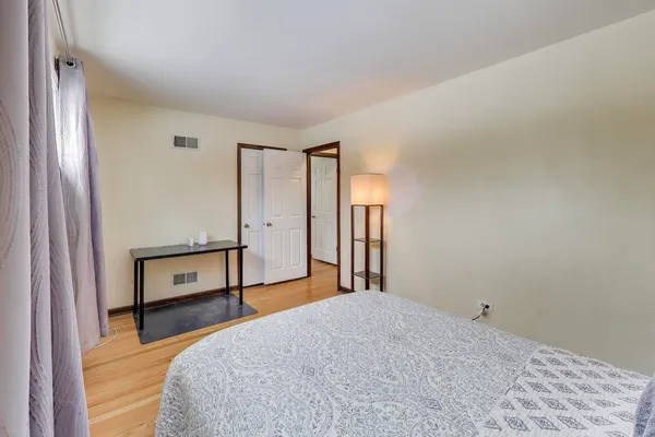 a bedroom with a large bed and a window