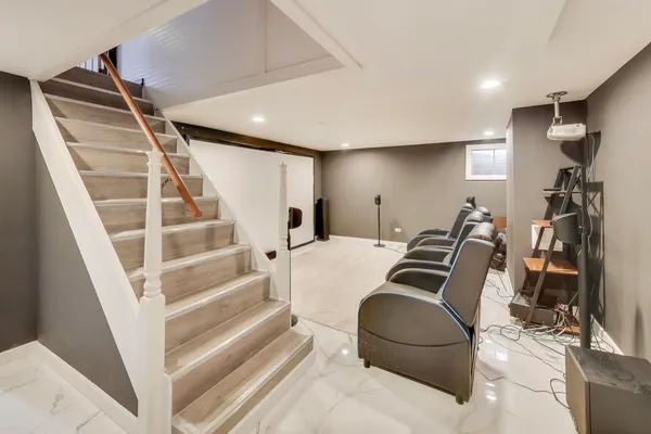 a living room with furniture and stairs