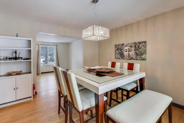 a view of a dining room with furniture and wooden floor
