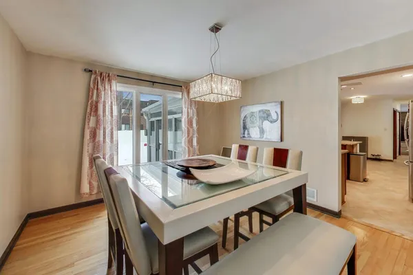 a view of a dining room with furniture window and wooden floor