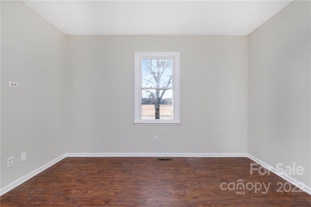 13809 Mayes Road Huntersville, NC 28078 - Photo 14 of 15 a view of an empty room with wooden floor and a window