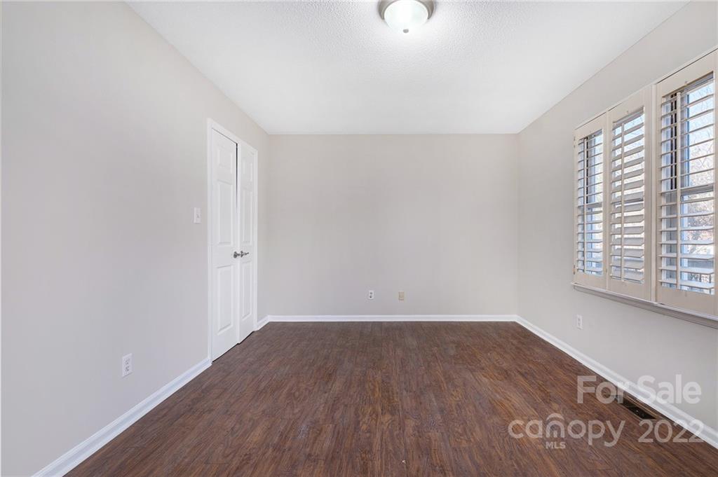 13809 Mayes Road Huntersville, NC 28078 - Photo 15 of 15 an empty room with wooden floor and windows