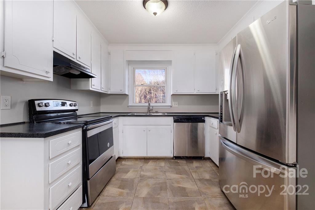 13809 Mayes Road Huntersville, NC 28078 - Photo 2 of 15 a kitchen with stainless steel appliances granite countertop a refrigerator and a stove