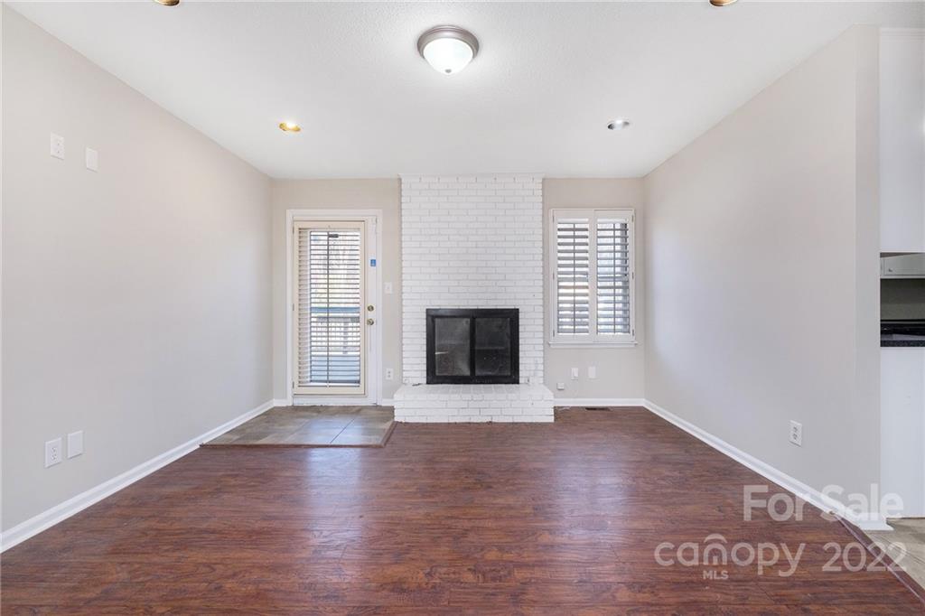 13809 Mayes Road Huntersville, NC 28078 - Photo 6 of 15 an empty room with wooden floor and windows