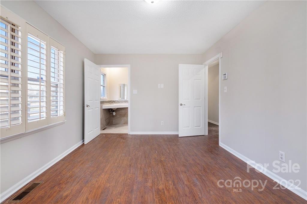 13809 Mayes Road Huntersville, NC 28078 - Photo 10 of 15 a view of an empty room with a window and wooden floor