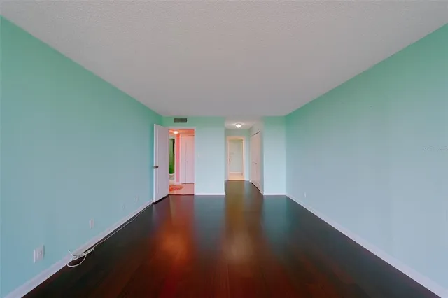 a bathroom with a tub a mirror and a shower