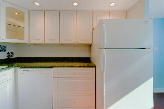 a white refrigerator freezer sitting inside of a kitchen