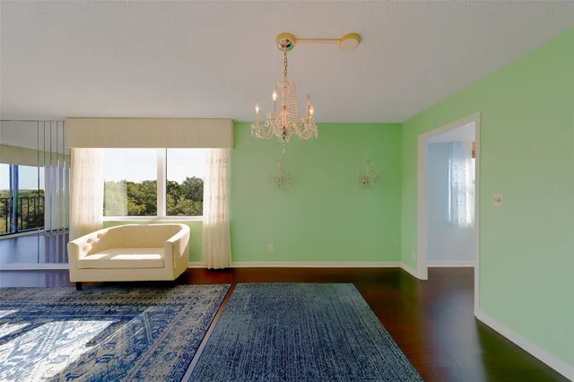 a living room with a bed furniture and a large window