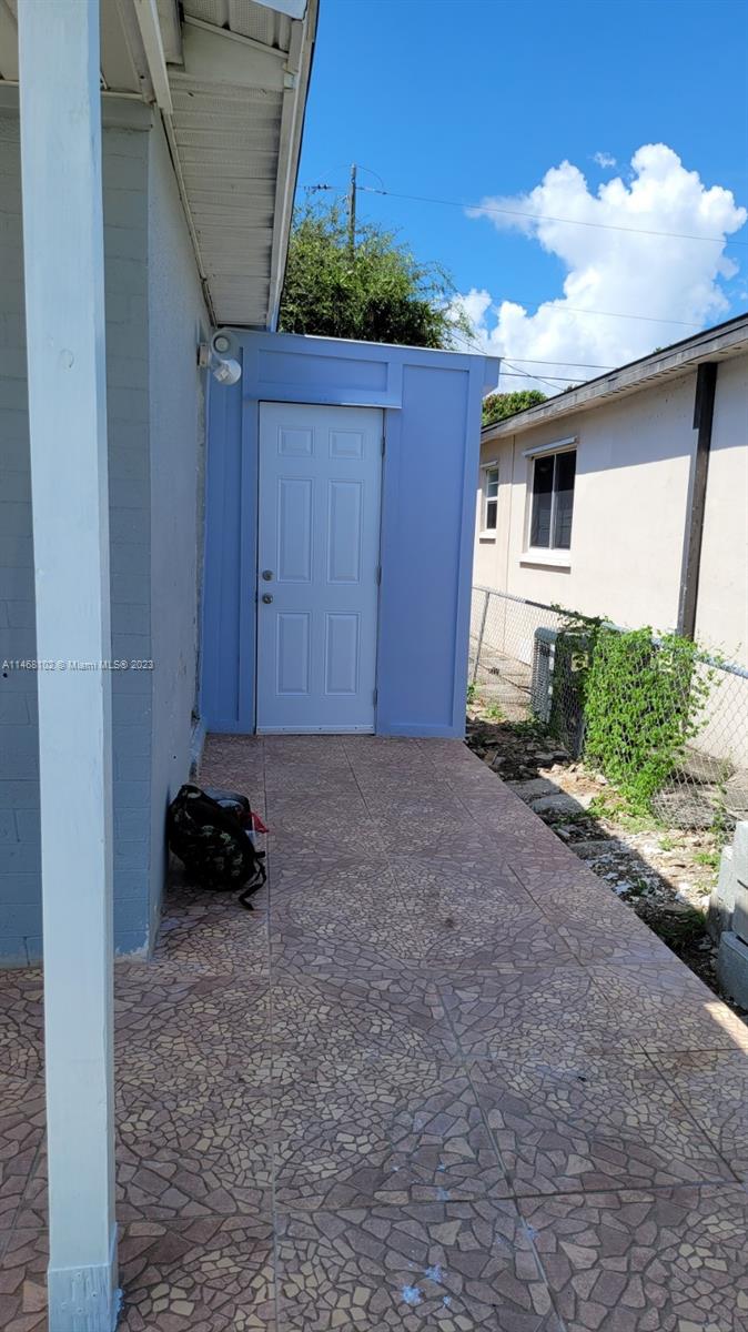 935 West 5th Street, Unit 935 Riviera Beach, FL 33404 - Photo 11 of 11 a view of backyard and wooden fence