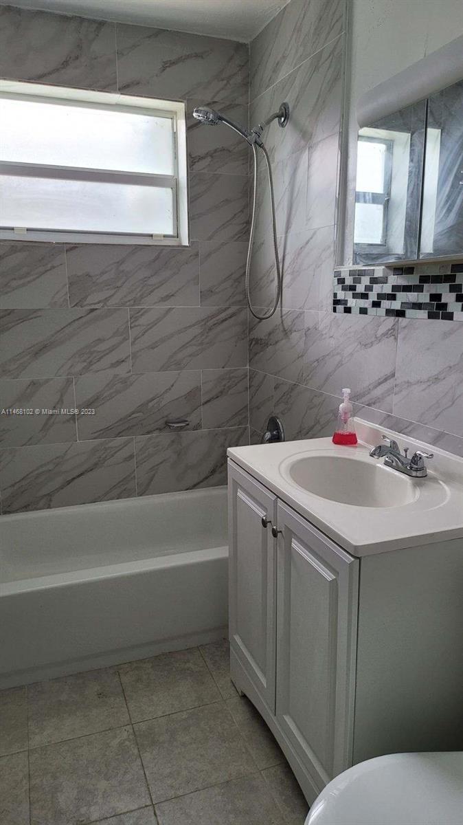 935 West 5th Street, Unit 935 Riviera Beach, FL 33404 - Photo 8 of 11 a bathroom with a sink and a mirror