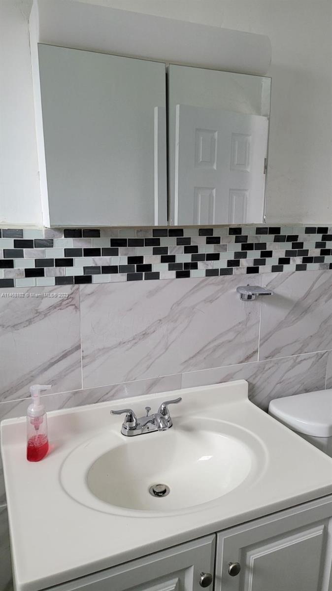 935 West 5th Street, Unit 935 Riviera Beach, FL 33404 - Photo 9 of 11 a bathroom with a sink and a mirror